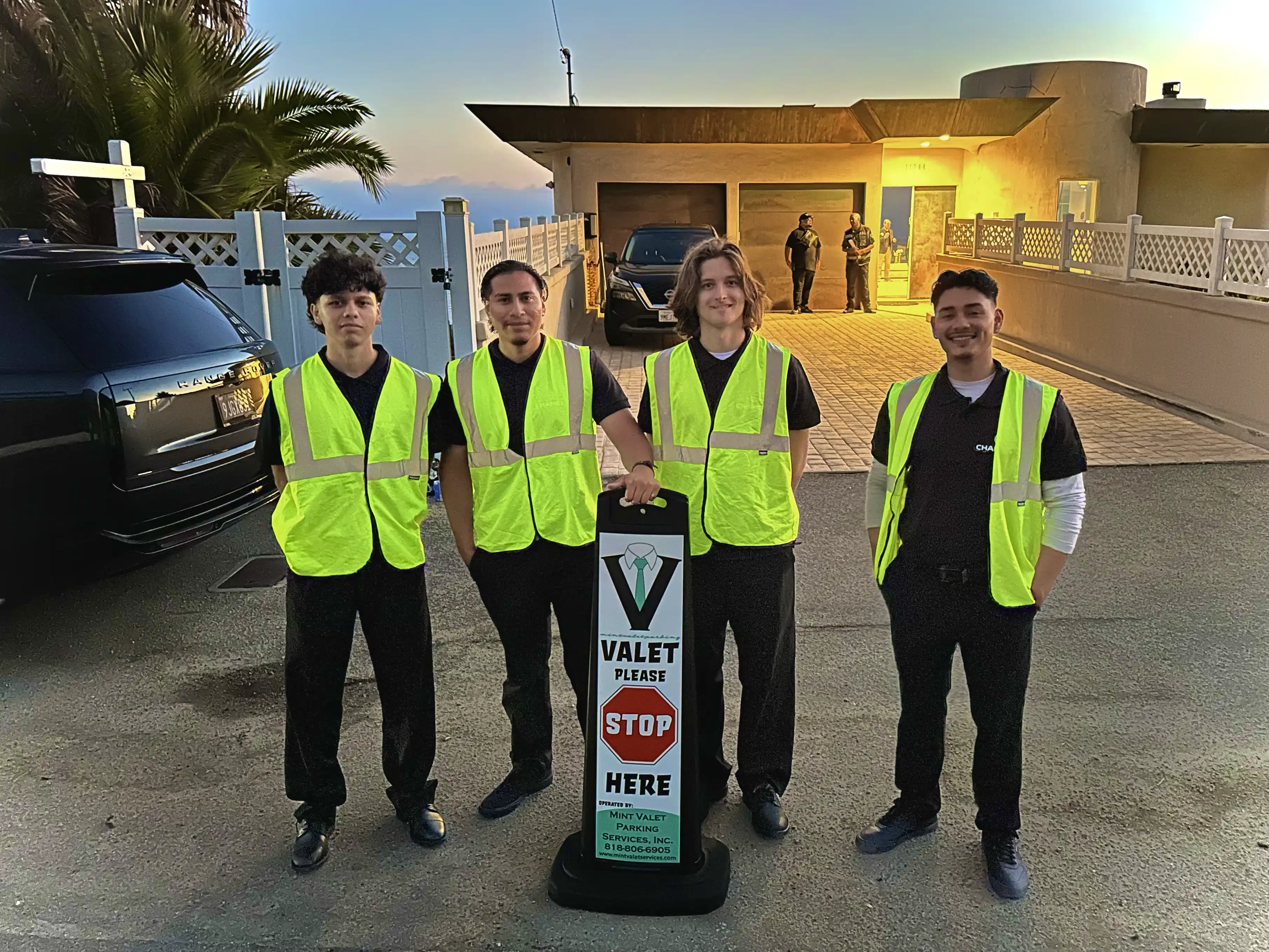 Mint Valet Parking Services attendants standing in front of a beach front house in Malibu. Providing premier Valet Service for a Malibu corporate private event